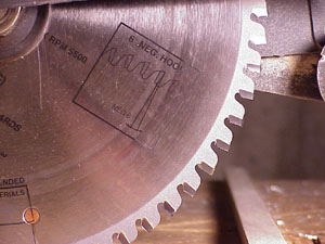 A carbide blade with negative hook angle was used to cut aluminum parts