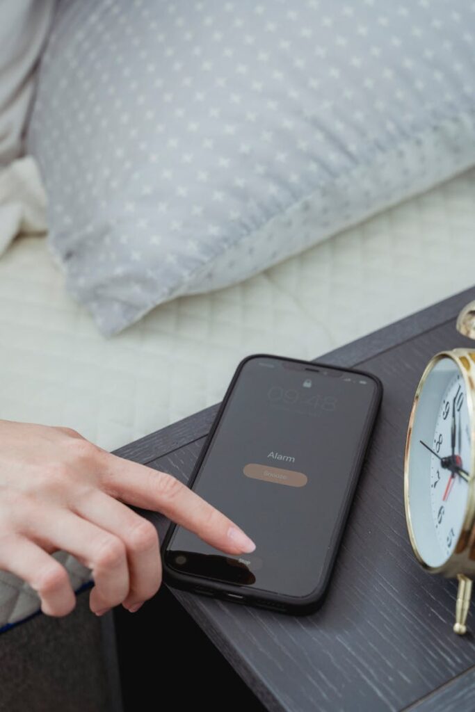 How do I customize my alarm sound on my iPhone?